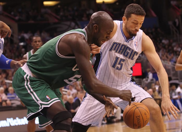 Boston Celtics power forward Kevin Garnett (5) and Orlando Magic small forward Hedo Turkoglu (15) go after the ball during the first quarter at Amway Center.
